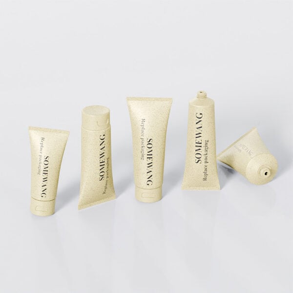 Five beige cosmetic tubes (D25mm to D40mm), labeled "Somewang" and "Revitalizing Mask," are made of plastic PE, on a gray background.