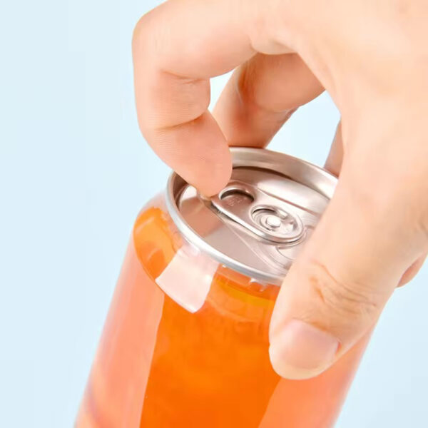 A hand opens a custom pop-top can of orange drink against a light blue background.