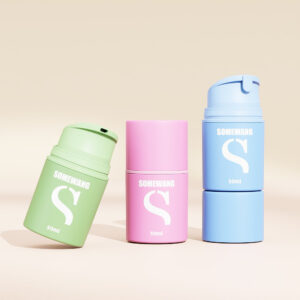 Three "Somewang" 50ml cosmetic containers in green, pink, and blue on a beige background.