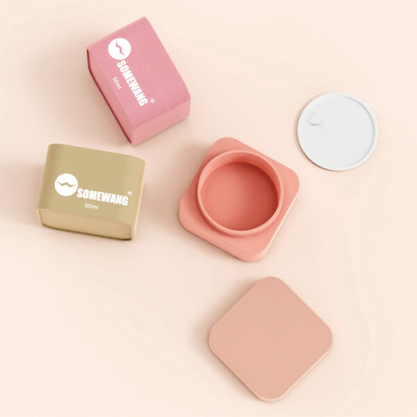 Four pink and beige "SOMEWANG 50ml" containers, lids off, are arranged on a light surface.