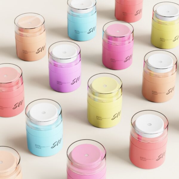 Những chiếc hộp hình trụ màu pastel có nắp trong suốt được sắp xếp gọn gàng thành hàng trên một bề mặt sáng.
