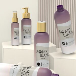 Five "SOME WANG" purple and white bottles sit on white pedestals before a neutral striped background.