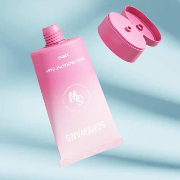 Um tubo rosa de 120 ml da SOMEWANG com tampa flip-top, parcialmente comprimido, flutua sobre um fundo azul: "FACILITE A EMBALAGEM.