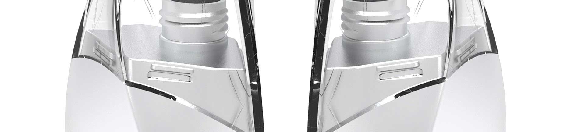 Close-up of two symmetrical, metallic and transparent cylinders with reflective surfaces on a white background.