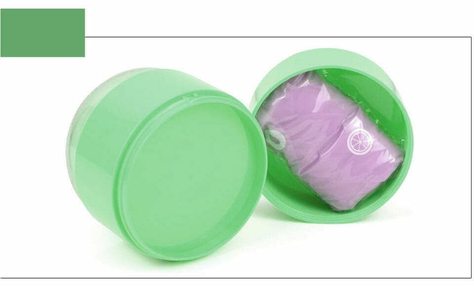 Two green cylinders—one open, showing a purple object inside—sit on a white surface.