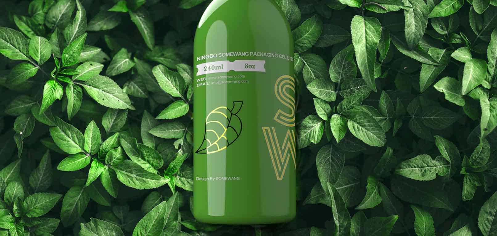 A green bottle with leaf designs and product details sits among lush green leaves.