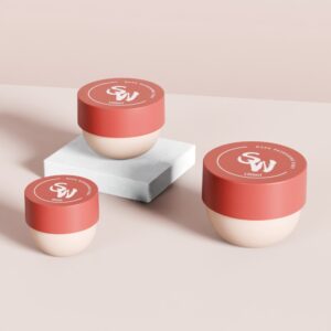 Three round PP jars (50ml, 100ml, 150ml) with red lids, white branding on a pink surface; one on a marble platform.