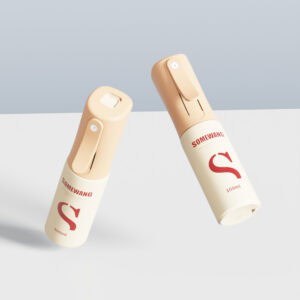Dua botol semprot HDPE 100ml berwarna krem dengan teks merah, satu tegak dan satu miring, pada latar belakang terang.